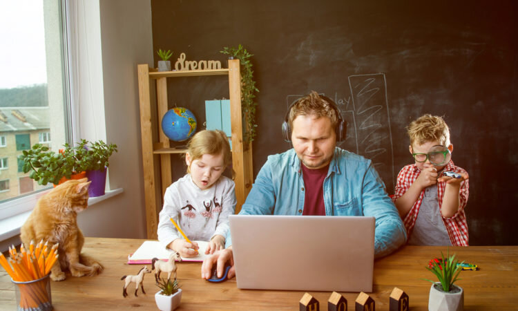 Man working on the table with his Children around 